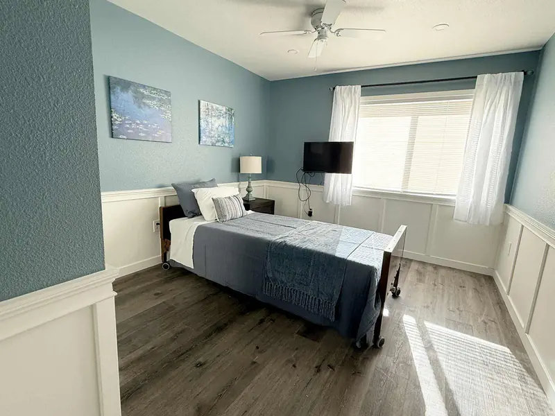Blue room with a single bed and window