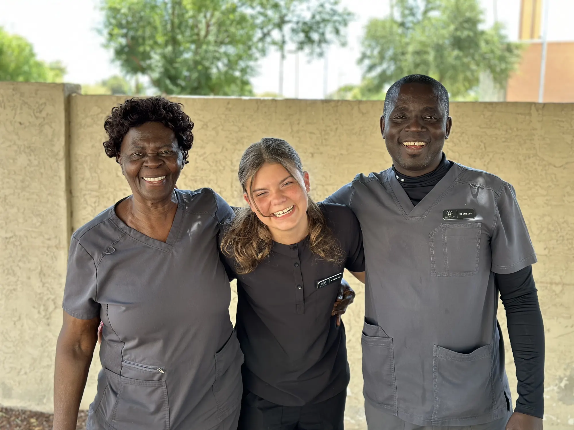 Fountain caregivers Mary, Ashlyn and Peter together outside the home