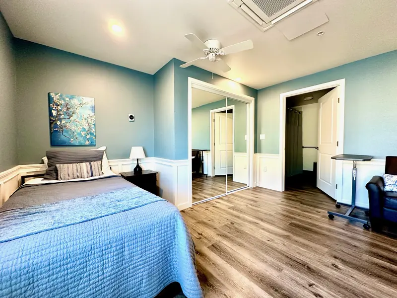 Wide view of a companionship room with two beds and seating