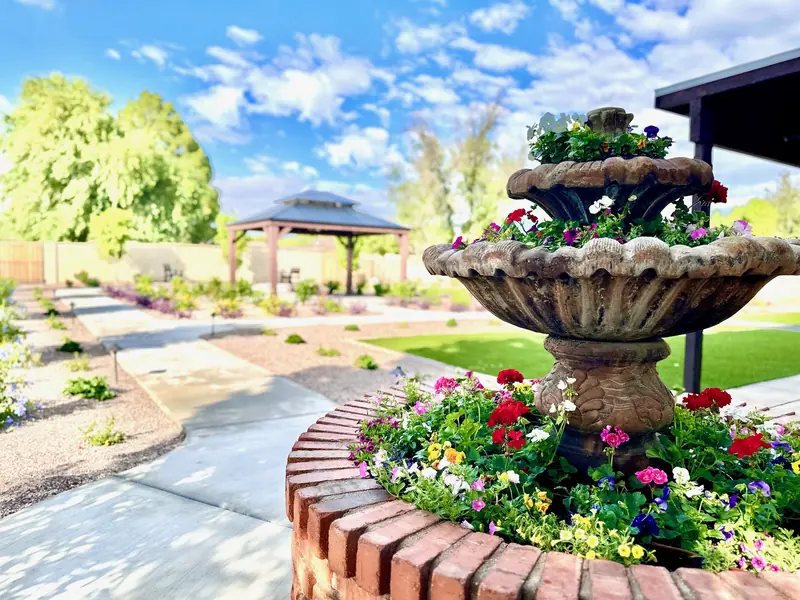Tiered fountain with red and pink flowers