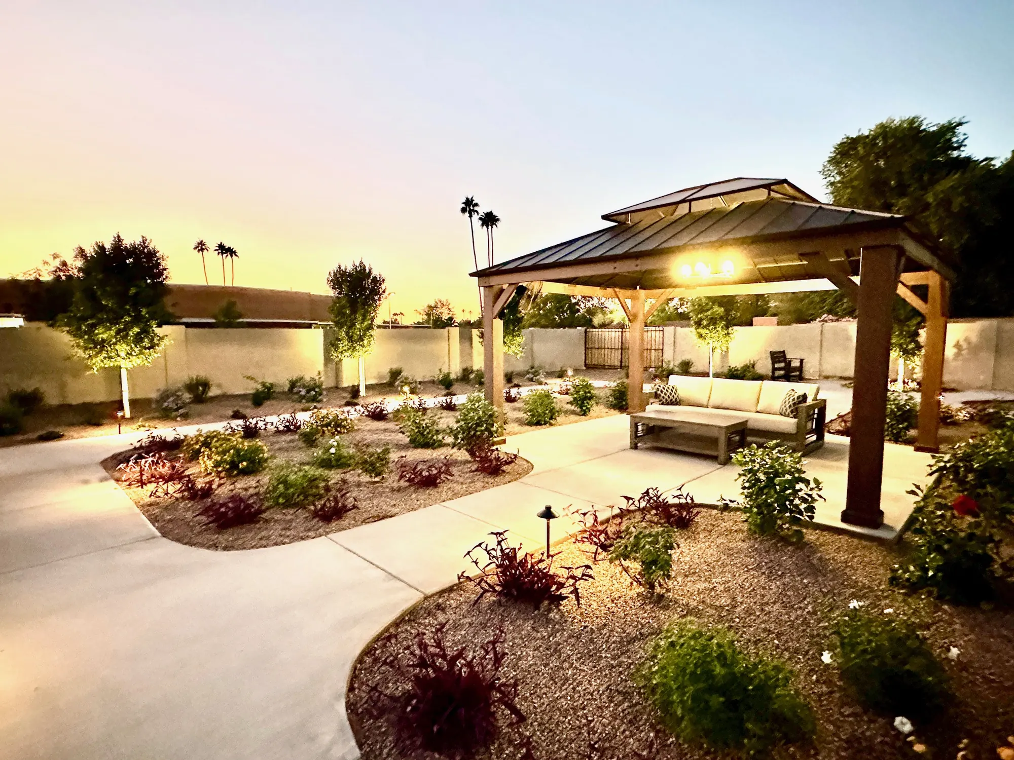Gazebo with outdoor seating and string lights at sunset