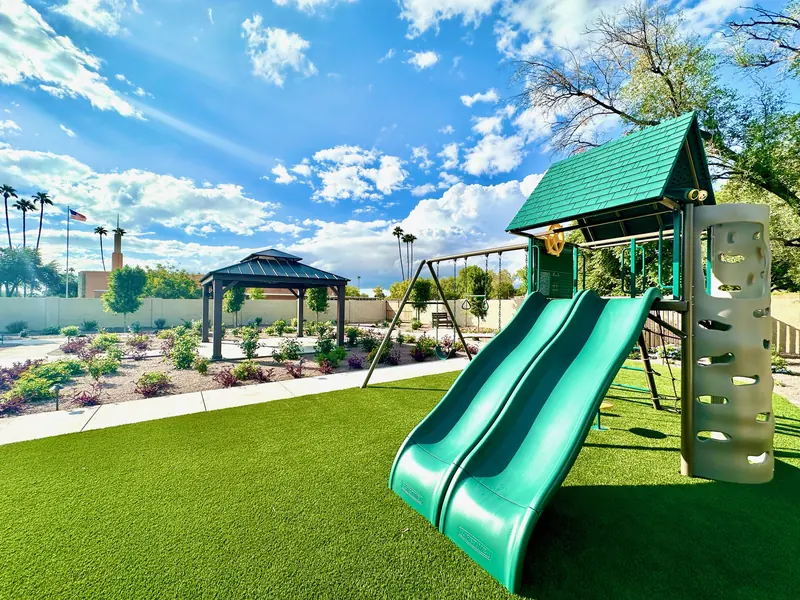 Green play set and slide for visiting grandchildren